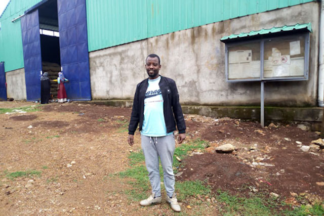 Muhdin Mohammed in front of his coffee hulling station