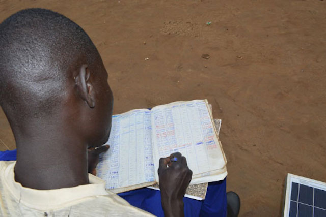 A farmer in Uganda tracks his earnings
