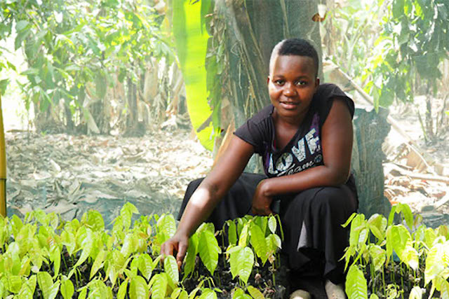 Young entrepreneur Mariam Sanga displaying seedlings in Tanzania