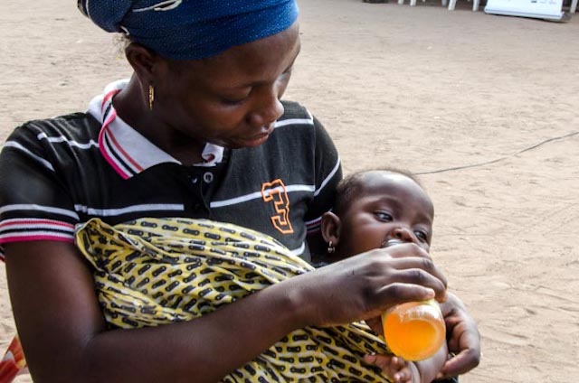 Mother feeding her baby Sweet Benin