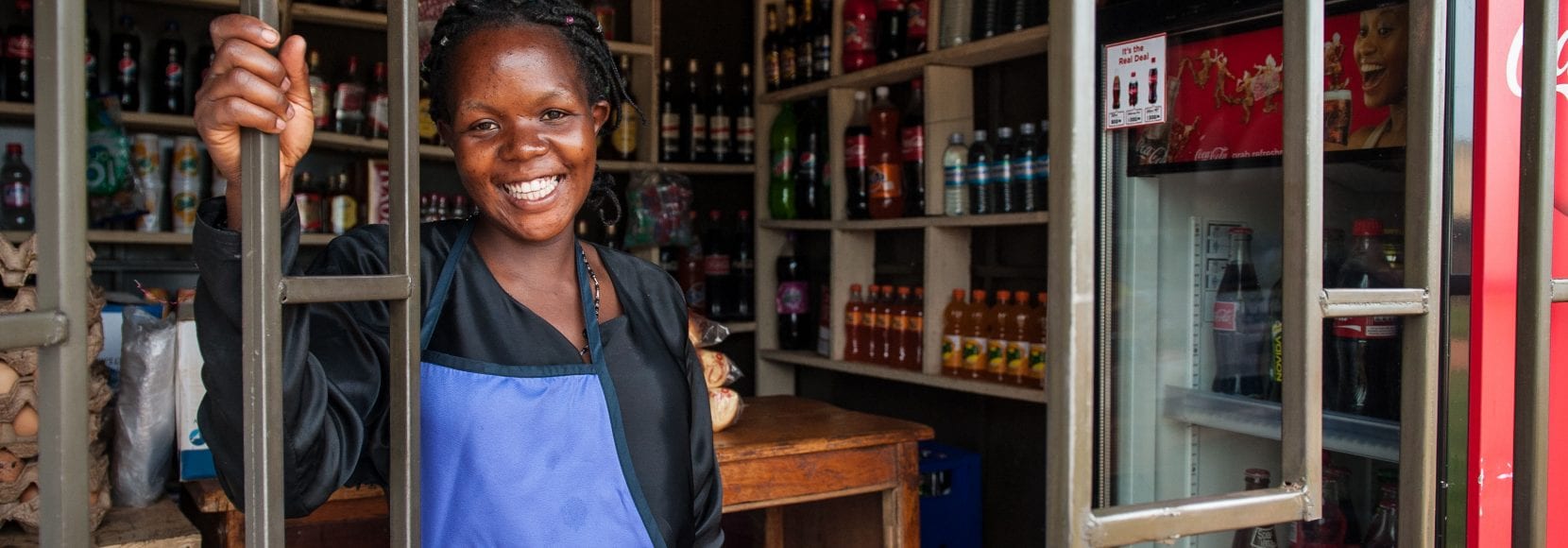 Woman smiling in her store in Uganda