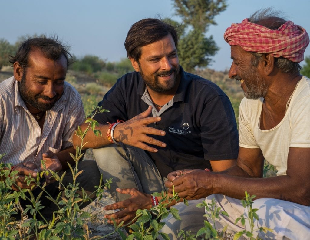 TechnoServe project manager discusses plant diseases with farmers in India