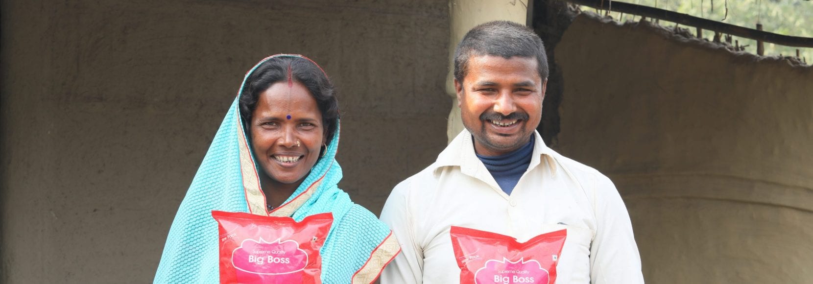 Smiling couple holding food up