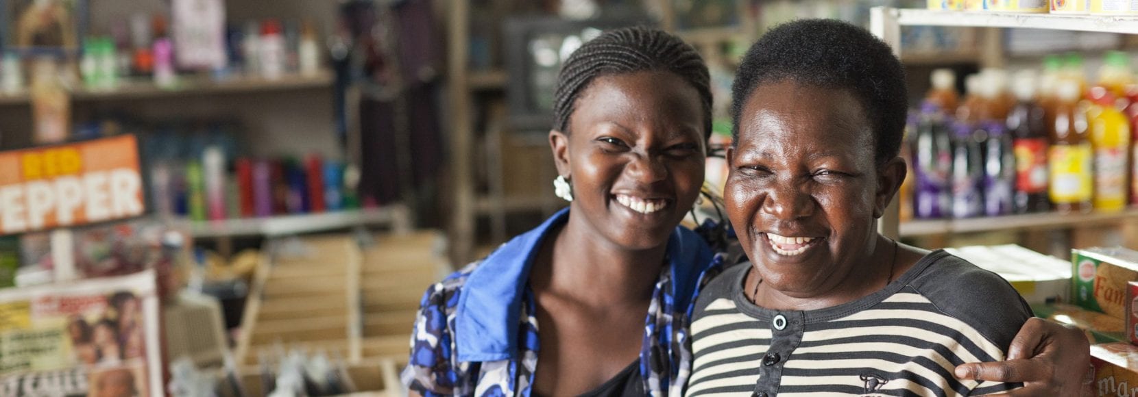 Two smiling women in grocery store in Uganda