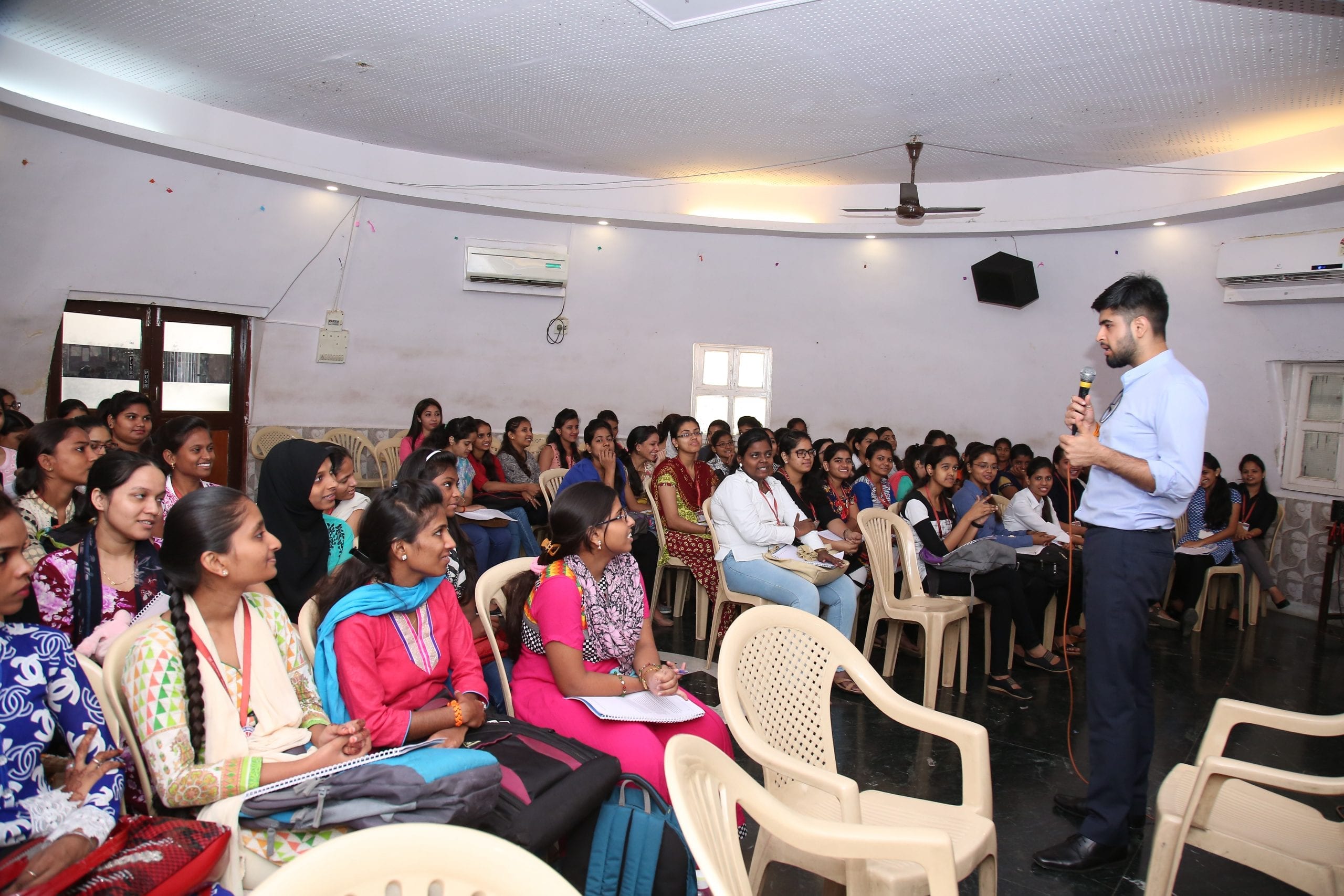 A group of young adults learning about formal work opportunities at a workshop in India