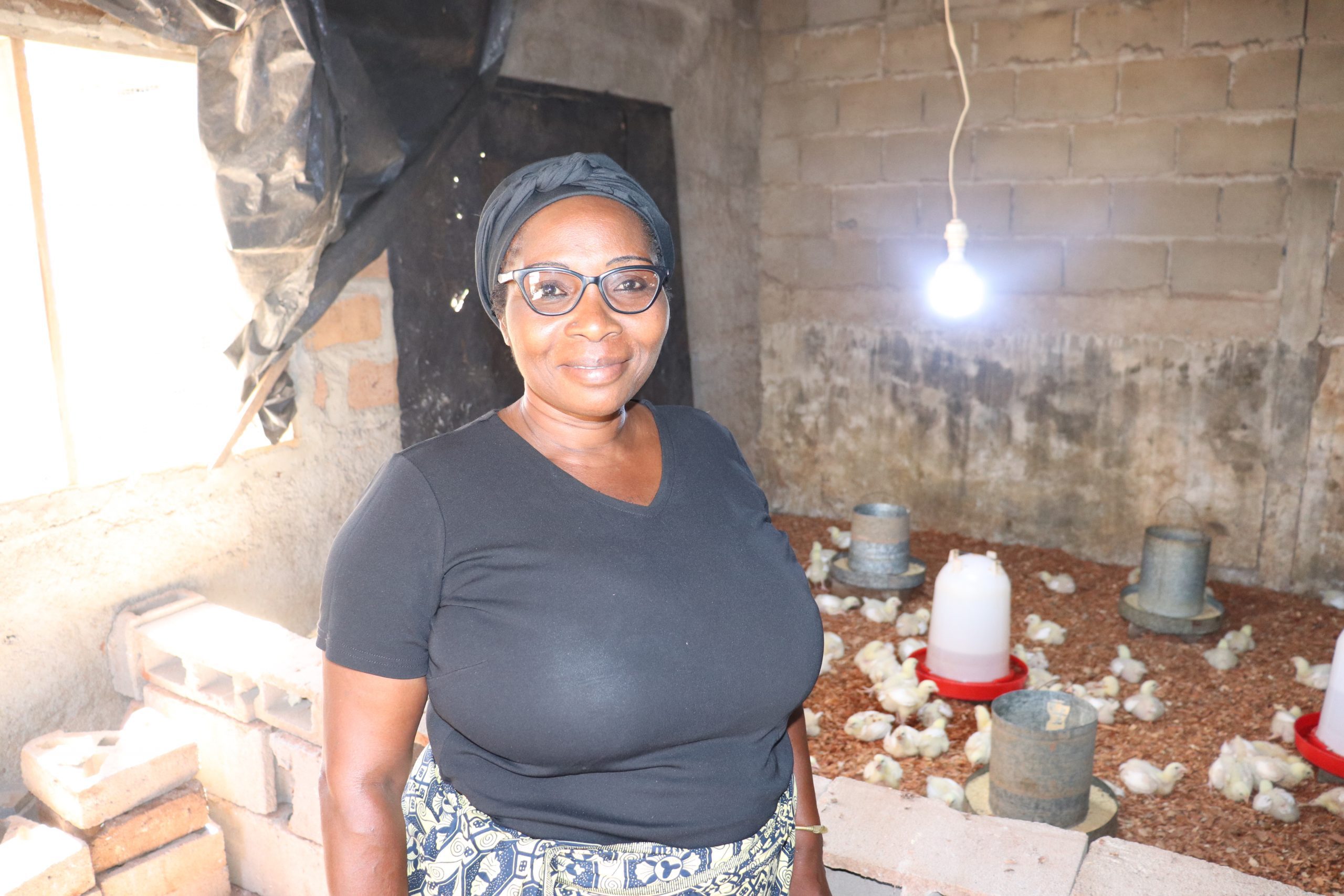 Helena Manura stands in her chicken coop in Cabo Delgado, Mozambique