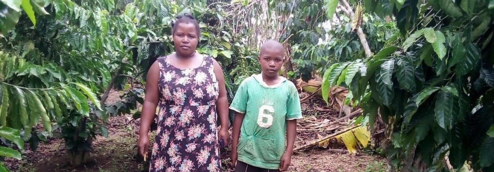 As Coffee farmers face the COVID-19 Crisis worldwide, Biringwa is no exception. Featured here, she stands with her son on their farm in Uganda