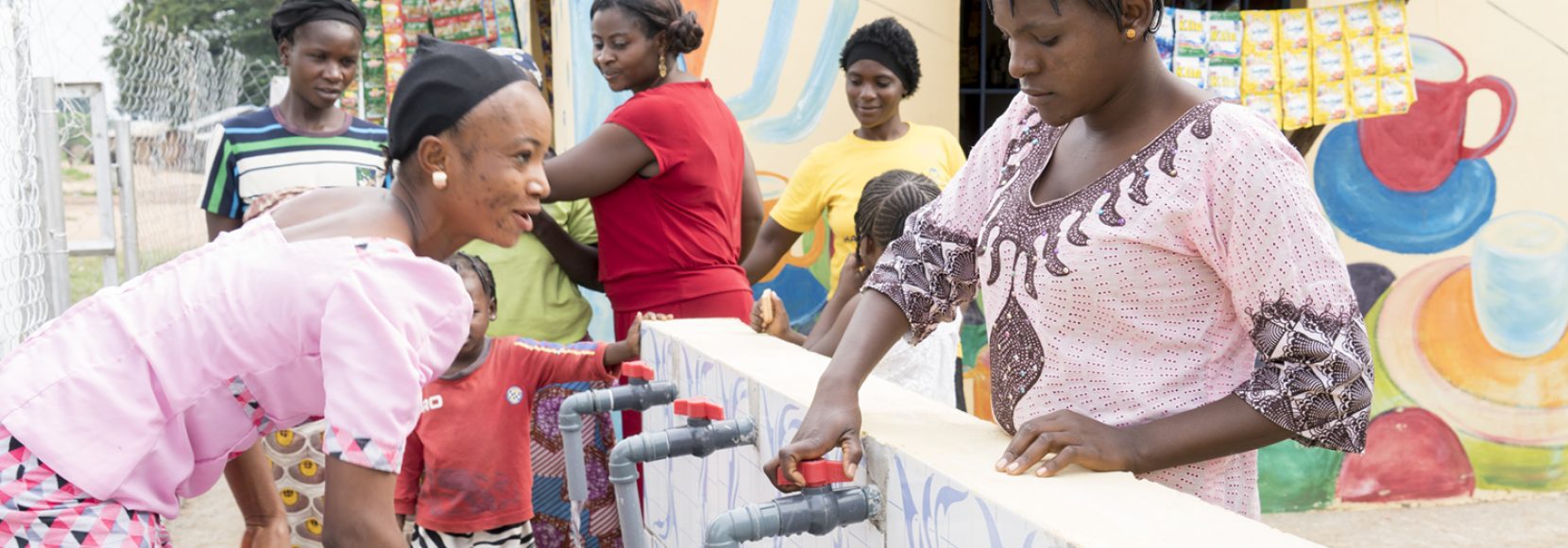 A group of women, all impacted by unpaid care work in their own way, gather water in Nigeria
