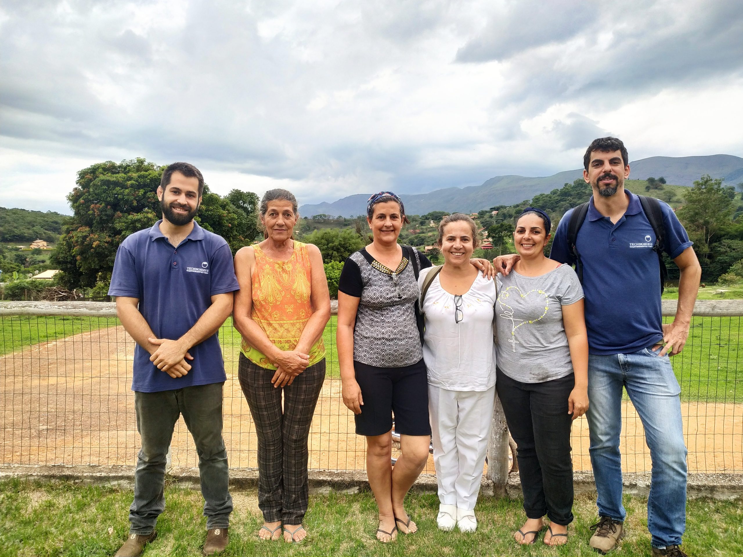 The women who started Talento do Campo stand with two TechnoServe advisors.