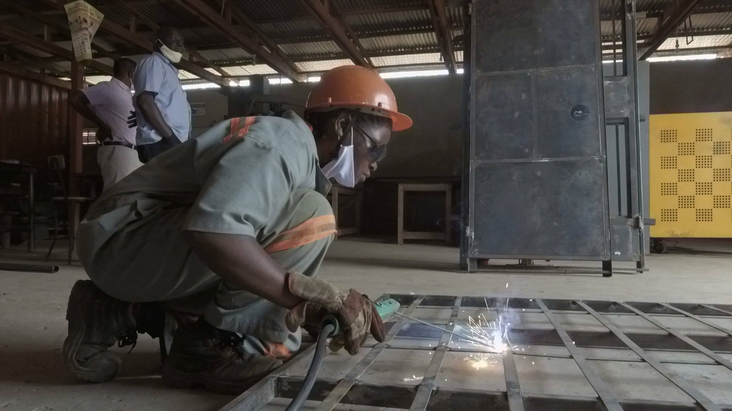 A young person welds near Kampala, Uganda