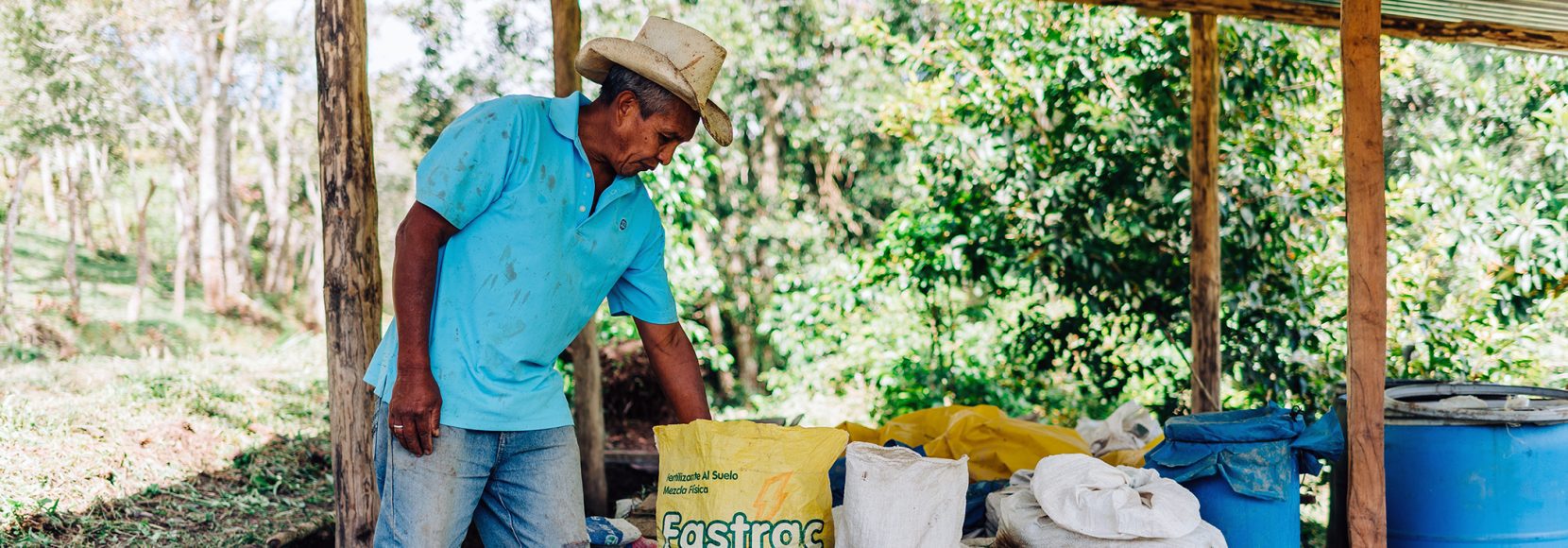A coffee farmer organizes his fertilizer supply. In Honduras, COVID-19 has significantly impacted commercial agriculture.