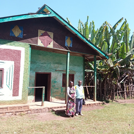 Amanuel is a coffee farmer dedicated to elevating his community, seen here with his wife, Zewditu, in front of their home 