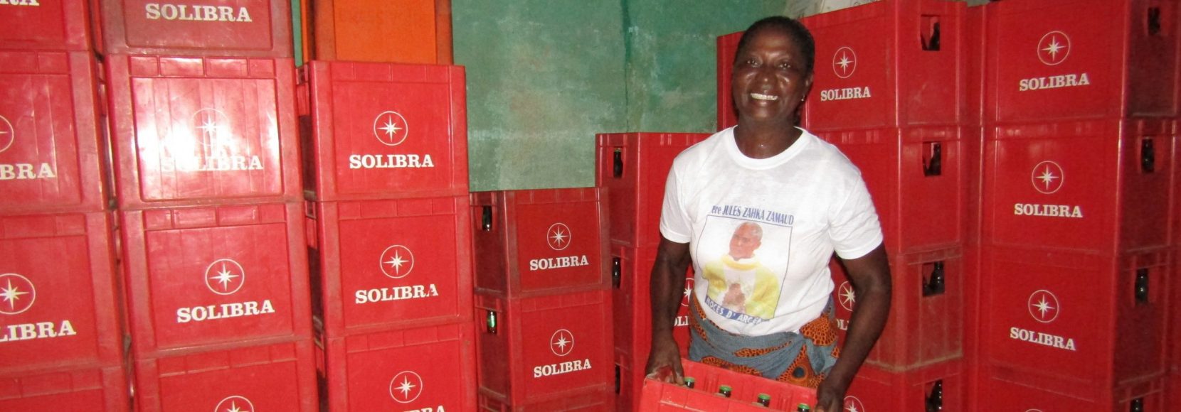 woman entrepreneur in Cote d'Ivoire working in her warehouse and smiling at the camera