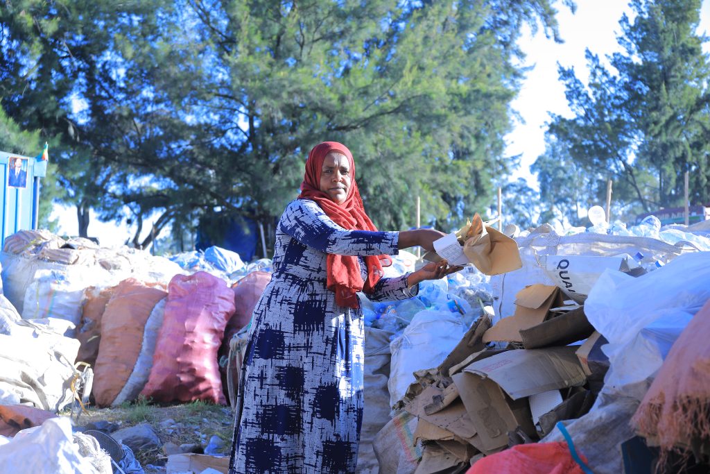Woman collecting waste materials in Addis Ababa, Ethiopia for recycling and community empowerment