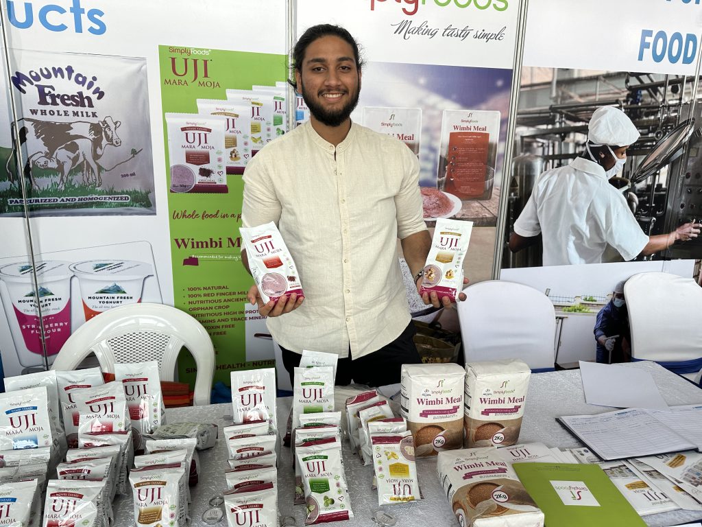 A team member from Simply Foods showcasing millet instant porridge at the Nairobi International Trade Fair 2023. World Food Day feature. 