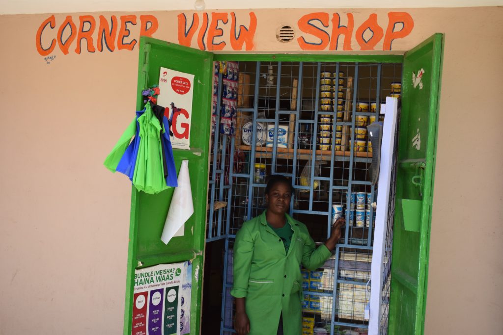 A client of TechnoServe's entrepreneurship program stands outside her corner shop in Kenya, one of four countries where PAYED helped build youth employment in Africa.  