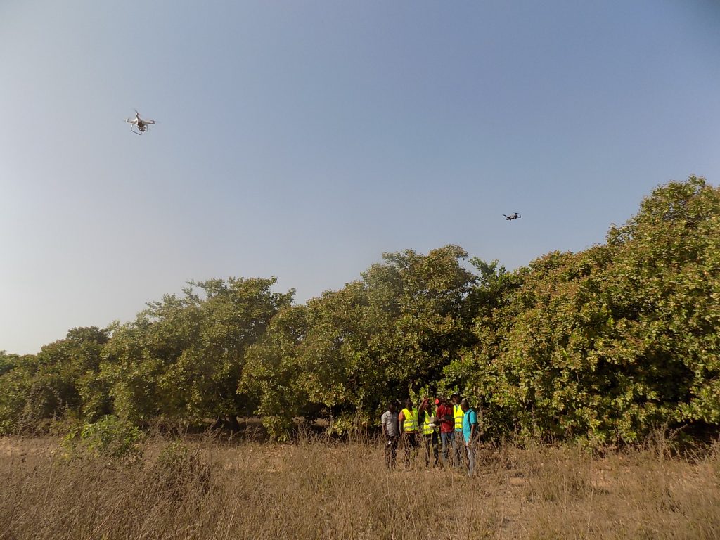 Drones flying over a field in Benin.
