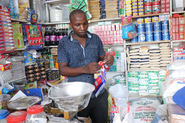A young man in his micro-retail store in Tanzania where he has successfully doubled his daily sales thanks to TechnoServe's youth entrepreneurhip program. 