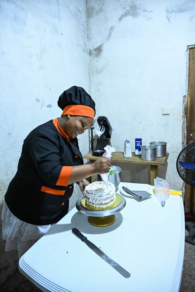A woman entrepreneur decorates a cake in a bakery in northern Mozambique.