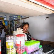 A woman entrepreneur stands in her small shop with her daughter in Nampula, Mozambique.