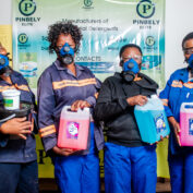 Four women stand with their products in Botswana. Part of a blog post on empowering women.